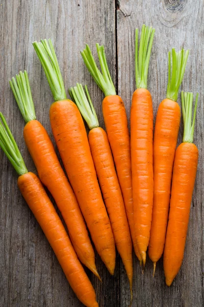Fresh carrots bunch on rustic wooden background. — Stock Photo, Image