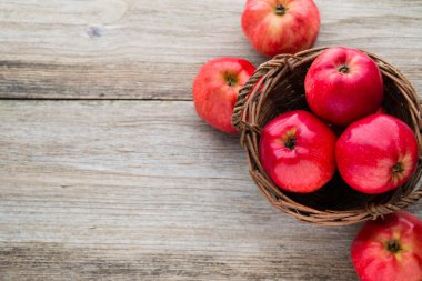Tahta arka planda olgun kırmızı elmalar.