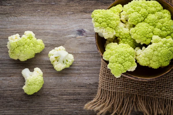 Rainbow of eco cauliflower on the wooden table. — Stock Photo, Image