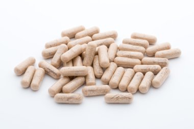 Beyaz arkaplanda Ginkgo biloba kapsülü.