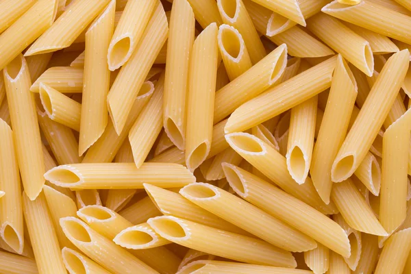 Italienische Makkaroni-Pasta voller Hintergrund. — Stockfoto