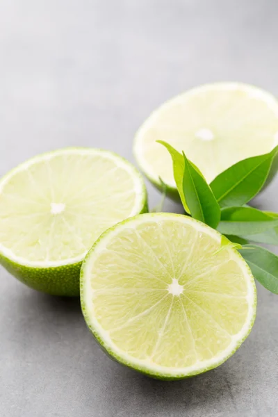 stock image Juicy ripe lime an gray table.