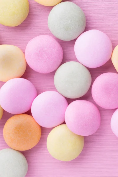 Candy. Small round candy-colored pastels on pastel background — Stock Photo, Image