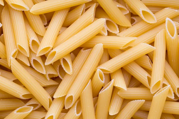 Italienska makaroner pasta full bakgrund. — Stockfoto