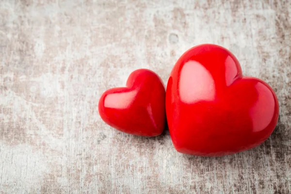 Corazón. Corazones de piedra roja en el fondo de madera . — Foto de Stock