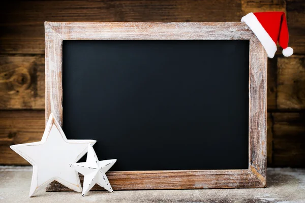 Christmas chalkboard with decoration. Santa hat, stars,  Wooden — Stock Photo, Image
