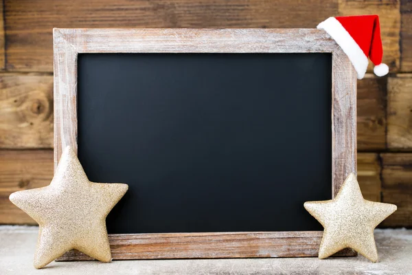 Christmas chalkboard with decoration. Santa hat, stars,  Wooden — Stock Photo, Image