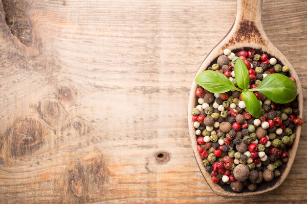 Spice mix a wooden spoon on a wooden background.
