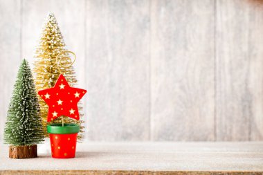 Golg and green christmas tree on a wooden background. clipart