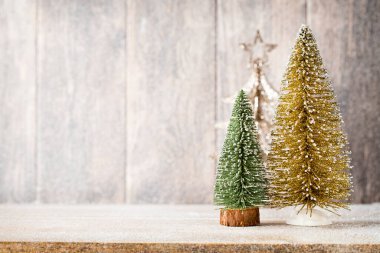 Golg and green christmas tree on a wooden background. clipart