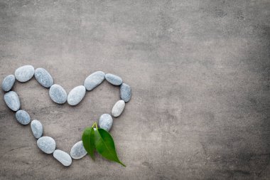 Kalp kaplıca taşlarından, gri arka planda..