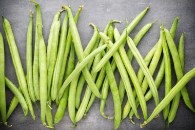 Gri arkaplanda yeşil fasulye.