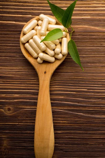 Vitamin Capsules Wooden Spoon Wooden Background — Stock Photo, Image