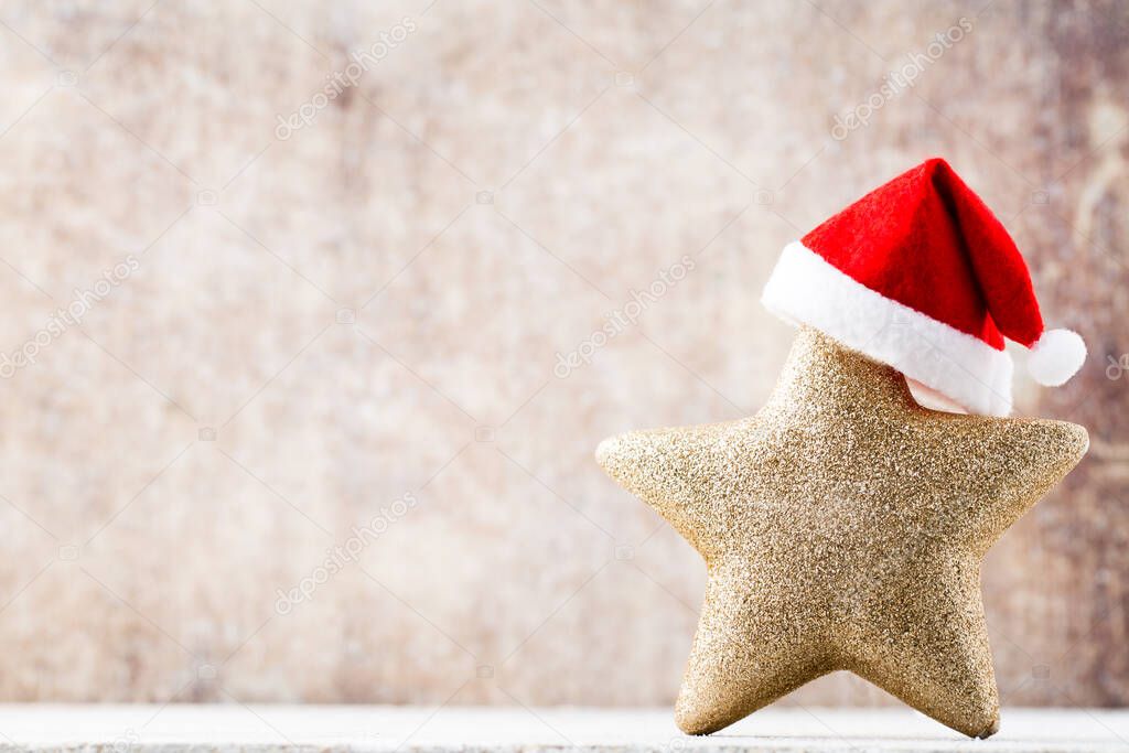 Christmas star with Santa hat. Vintages background.