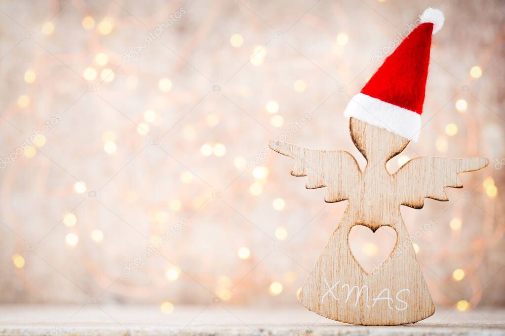 Christmas decor with angel santa hat. Vintages background.