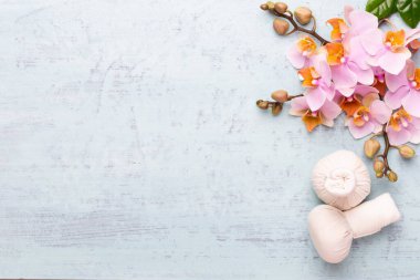 Spa aromaterapi arka planı, basit orkide çiçekleriyle süslenmiş çeşitli güzellik ürünleri..