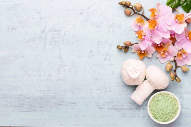 Spa aromaterapi arka planı, basit orkide çiçekleriyle süslenmiş çeşitli güzellik ürünleri..