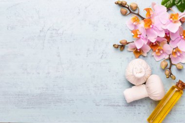 Spa aromaterapi arka planı, basit orkide çiçekleriyle süslenmiş çeşitli güzellik ürünleri..