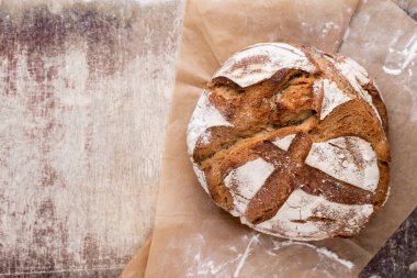 Koyu gri mutfak masasında taze pişmiş ekmek..