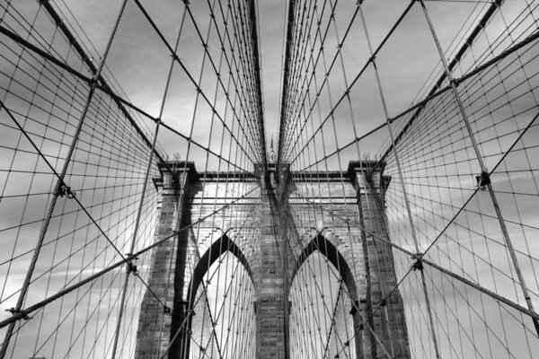 Black and white view of Brooklyn Bridge arches