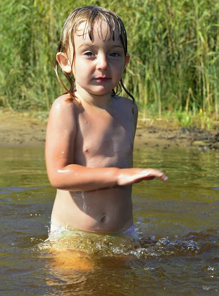 Little girl in water on sunny day — Stock Photo, Image