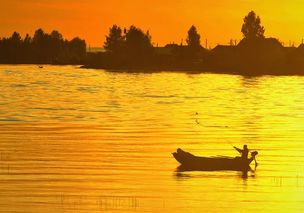 The boat with the fisherman at sunset — Stock Photo, Image