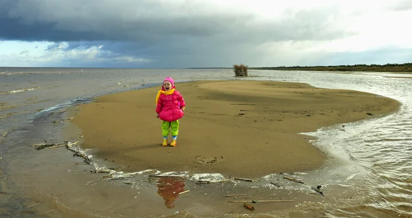 Bambina su una spiaggia di autunno di sabbia al tramonto . — Foto Stock