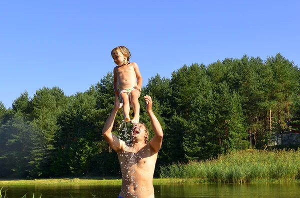 In the summer, bright sunny day, the little girl and man is bathed