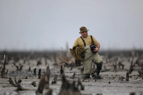 Photographer with photoequipment go on a bog — Stock Photo, Image