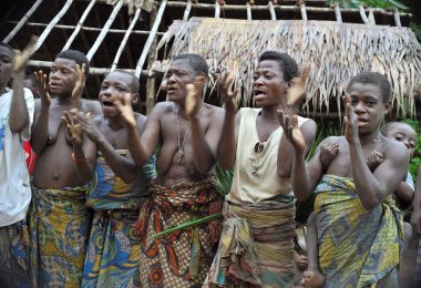 People from a tribe of Baka pygmies in village of ethnic singing. Traditional dance and music clipart