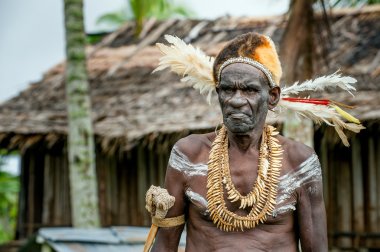 Asmats with a traditional painting on a face