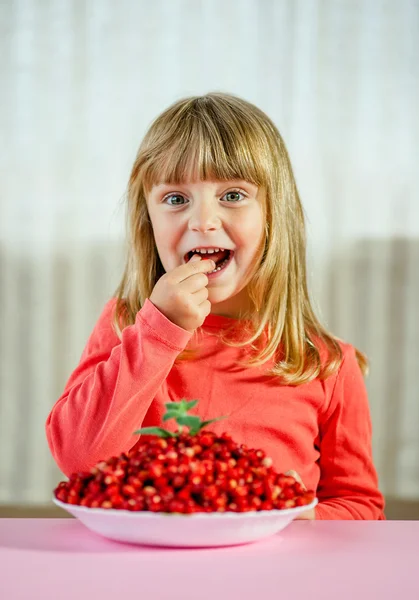 Little girl with wild strawberries, Stock Image