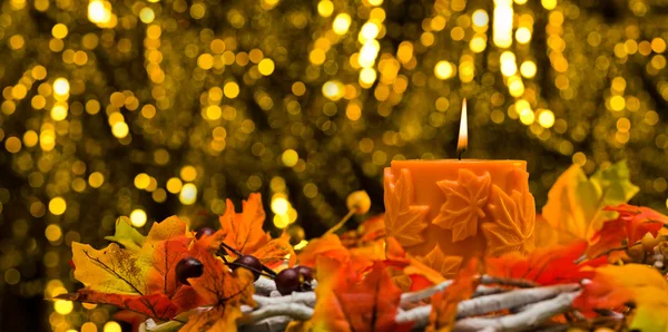 Orange candle in autumn Christmas setting — Stock Photo, Image