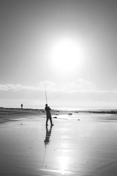 Pêcheur solitaire pêche au coucher du soleil Kerry plage — Photo