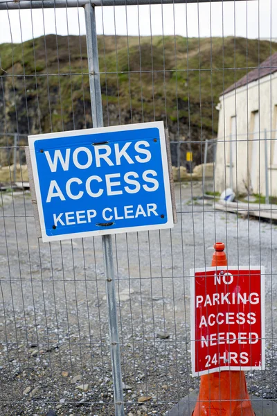 Signs on the boundary fence of a building site — Stock Photo, Image