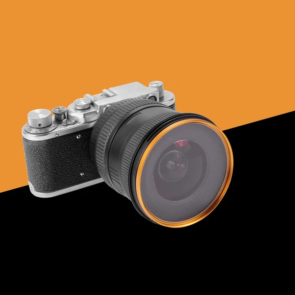 Retro film camera orange and black background — Stock Photo, Image