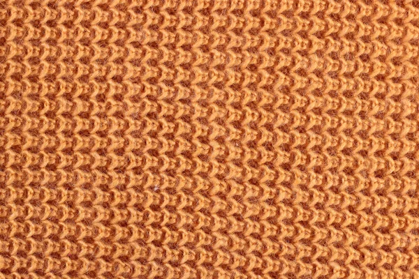 Texture of a orange knitted sweater