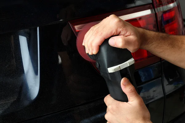 Car service. Polishing of rear optics of the car — Stock Photo, Image