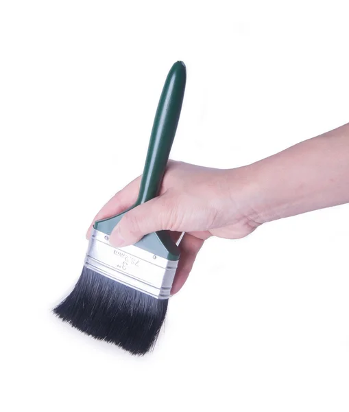 Paint brush or paint brush in a hand on background. — Stock Photo, Image