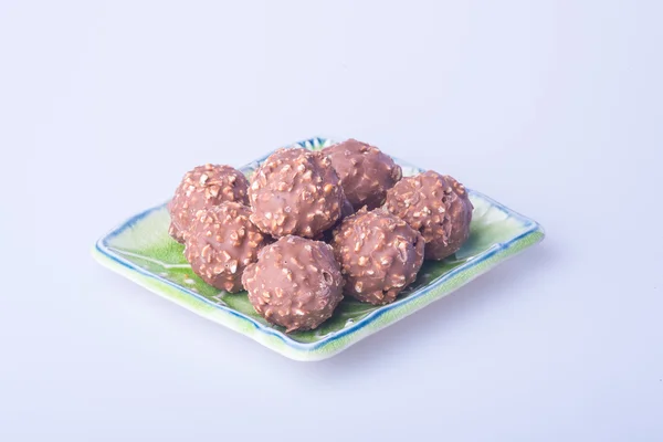 Chocolate ball or chocolate in plate on background. — Stock Photo, Image