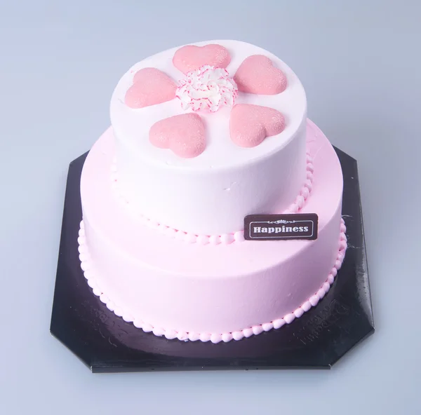 Kaka eller mödrar dag hjärtformade tårta på en bakgrund. — Stockfoto