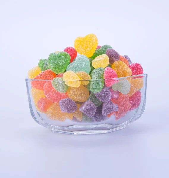 Цукерки. желе-цукерки в скляній мисці на фоні — стокове фото