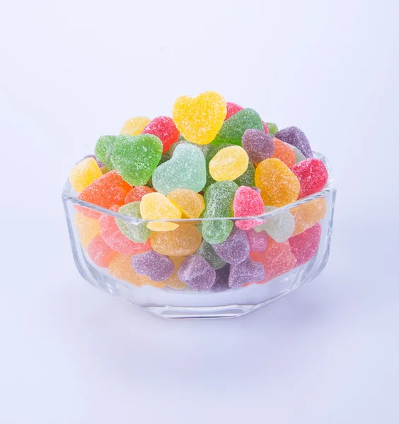 Цукерки. желе-цукерки в скляній мисці на фоні — стокове фото