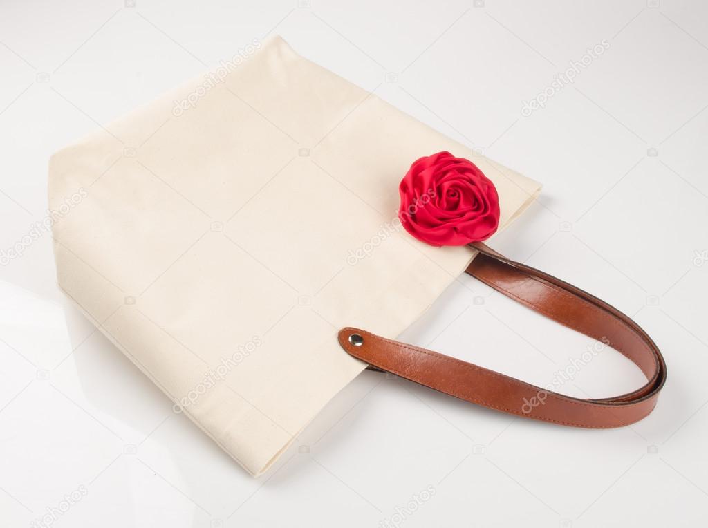 bag or shopping handbag with rose on background.