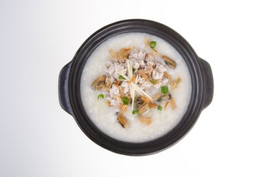 Traditional chinese pork porridge rice gruel served in claypot clipart