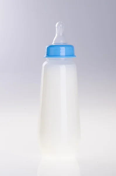 Baby bottle with milk on background — Stock Photo, Image