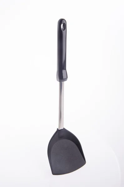 Black plastic kitchen spatula on background. — Stock Photo, Image