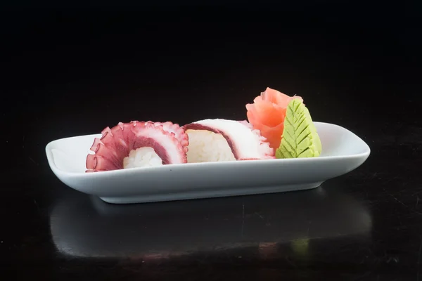 Japanse keuken. Sushi octopus op de achtergrond — Stockfoto