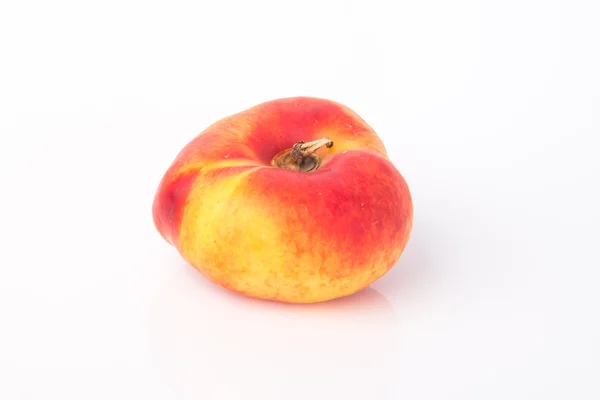 Flat peaches (donut peaches) on a background — Stock Photo, Image