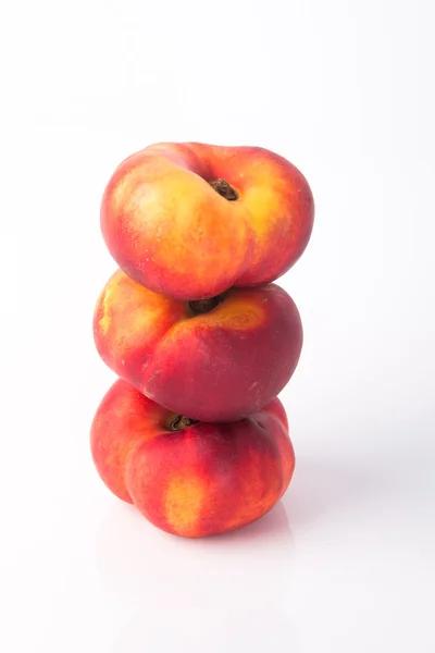 Flat peaches (donut peaches) on a background — Stock Photo, Image